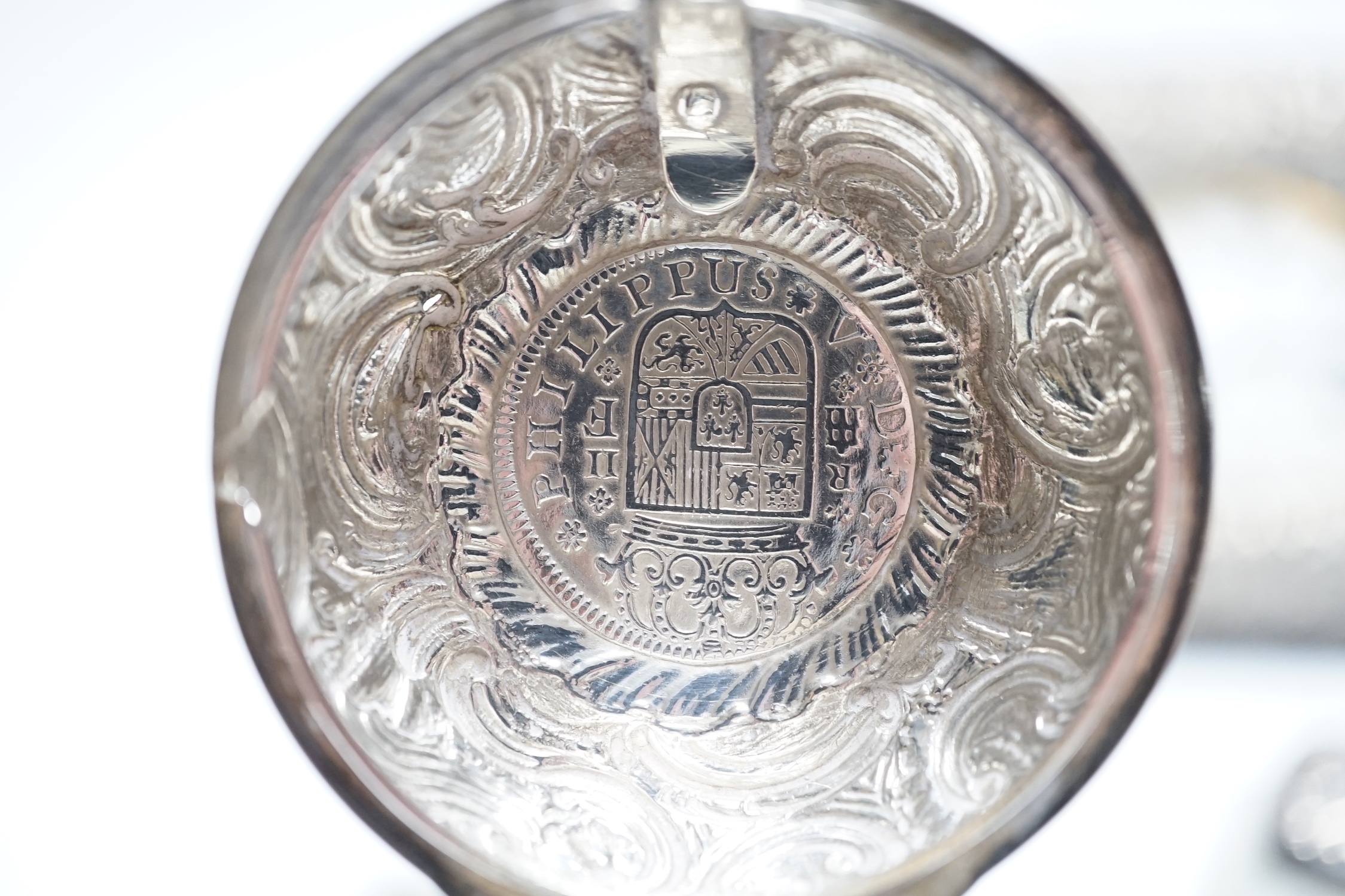 A late Victorian repousse silver mounted travelling pocket watch case, Birmingham, 1898, 11.6cm, with nickel cased pocket watch, together with five silver topped glass toilet jars.
